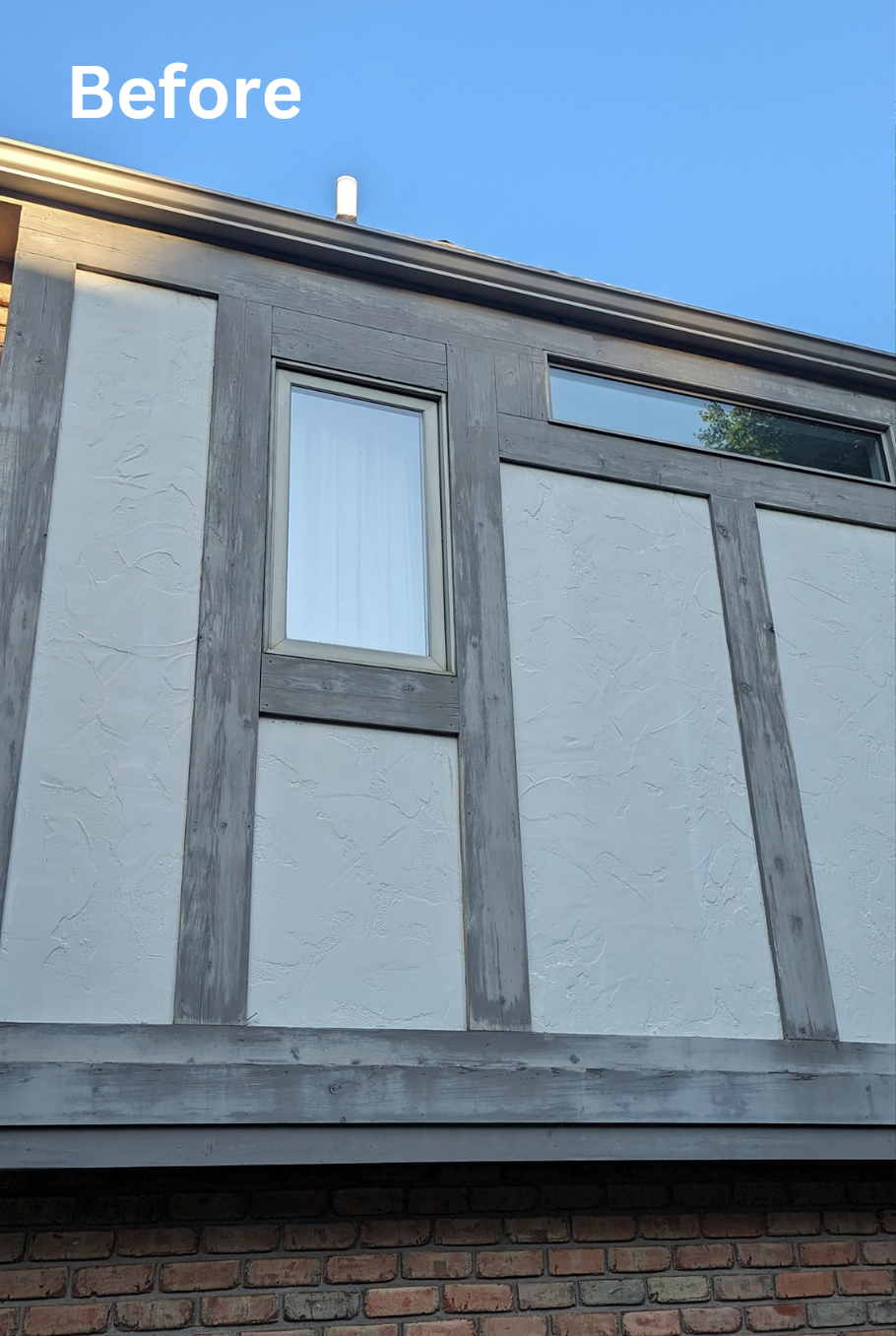 Before photo of a house exterior with gray panels, a window, and brickwork under a blue sky