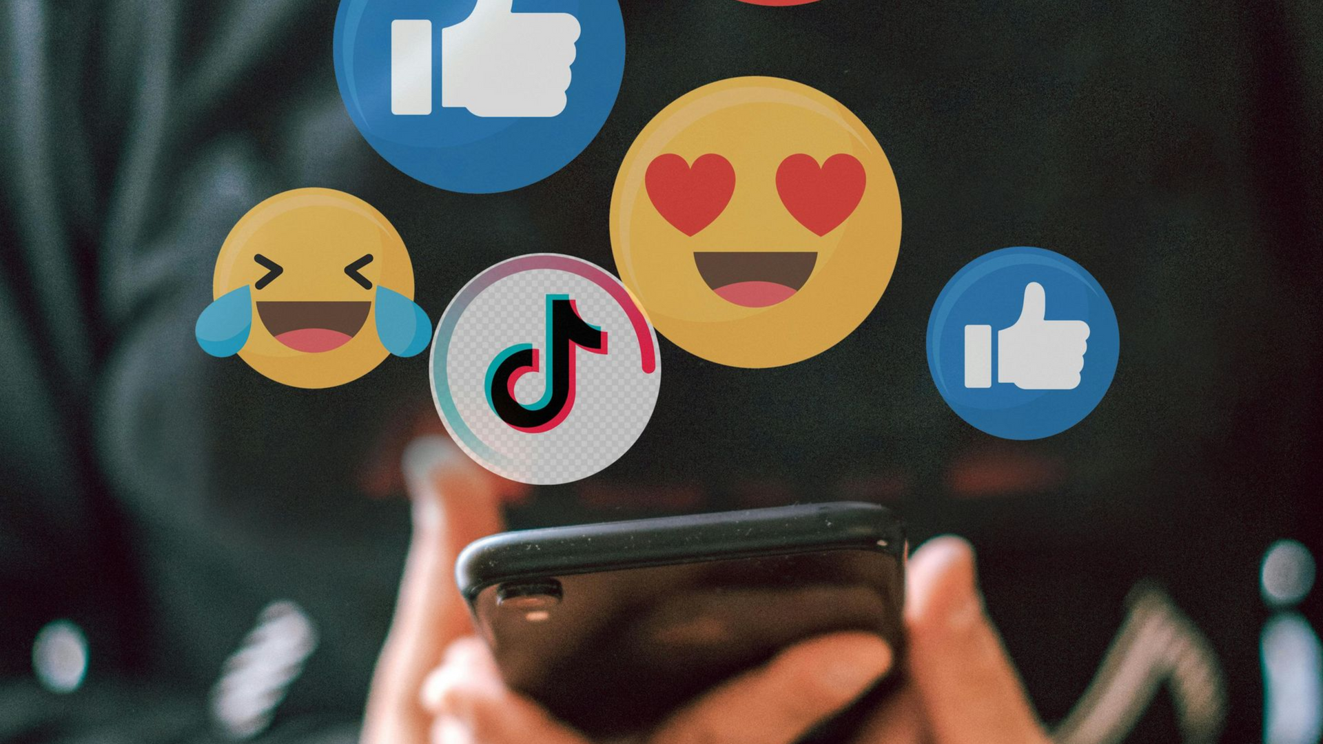 A person holding a smartphone surrounded by floating social media reaction icons, including TikTok and Facebook likes.