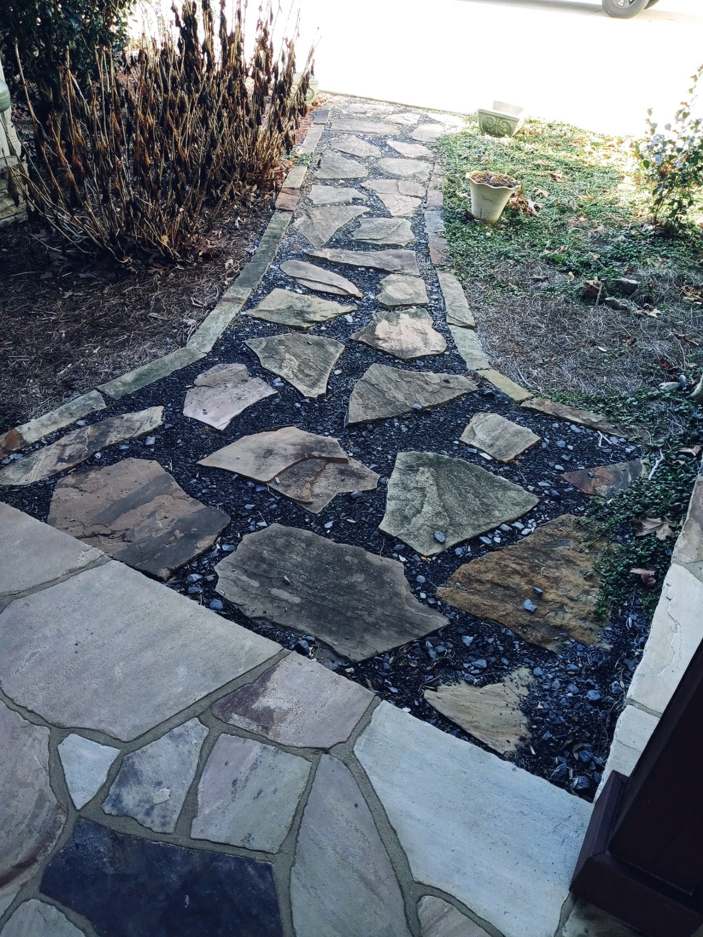 A stone path leading to a cabin in the woods.