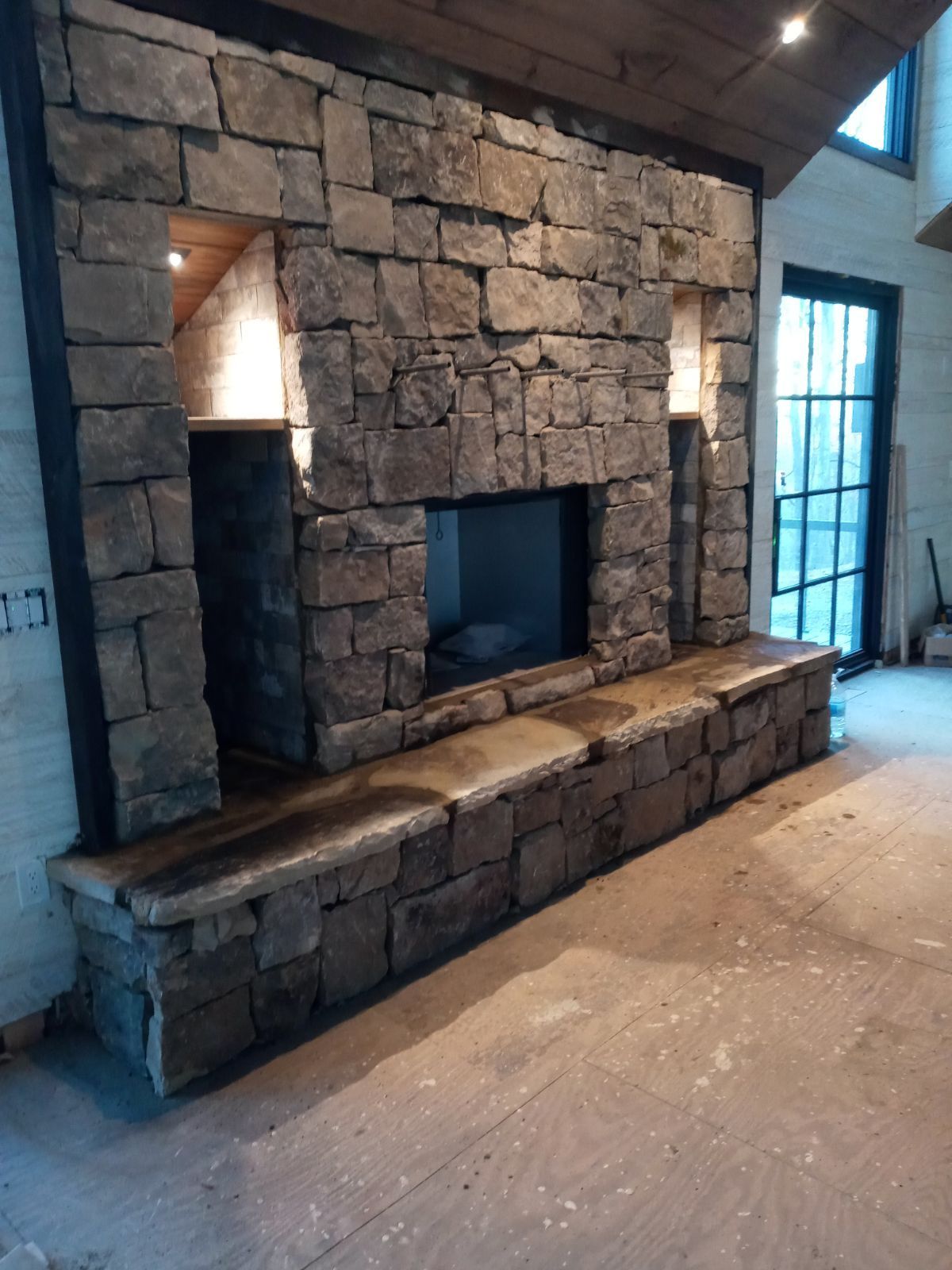 A stone walkway leading to a house in the woods
