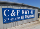 Blue sign on a storage building reads &ldquo;C&F Hwy 67 Self Storage Units&rdquo; with phone number 573-431-5757
