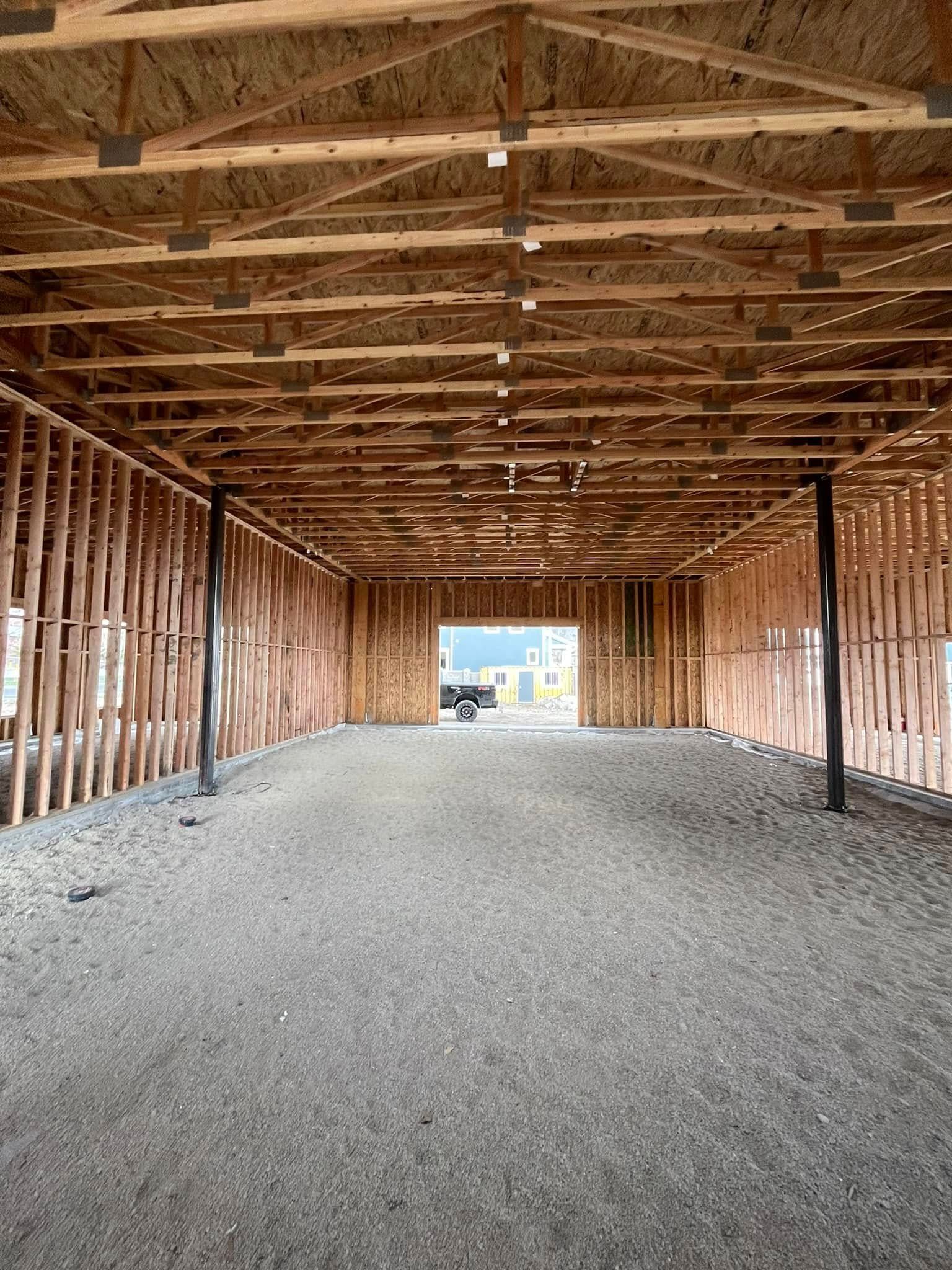 The inside of a building under construction with a lot of wooden beams.