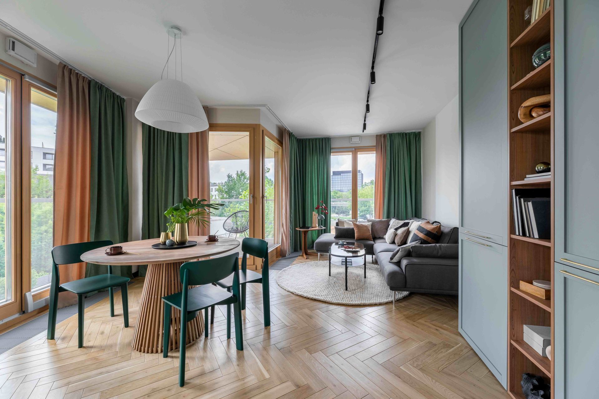 A living room with a table and chairs and a couch.