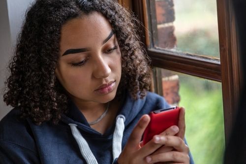 Teenage girl looking at cell phone.