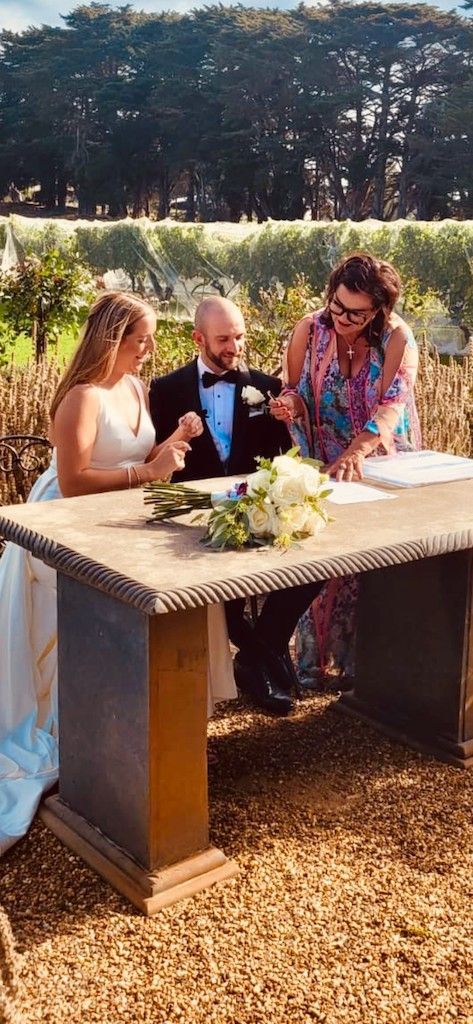 A Bride and Groom Are Signing Their Wedding Papers at A Table 
