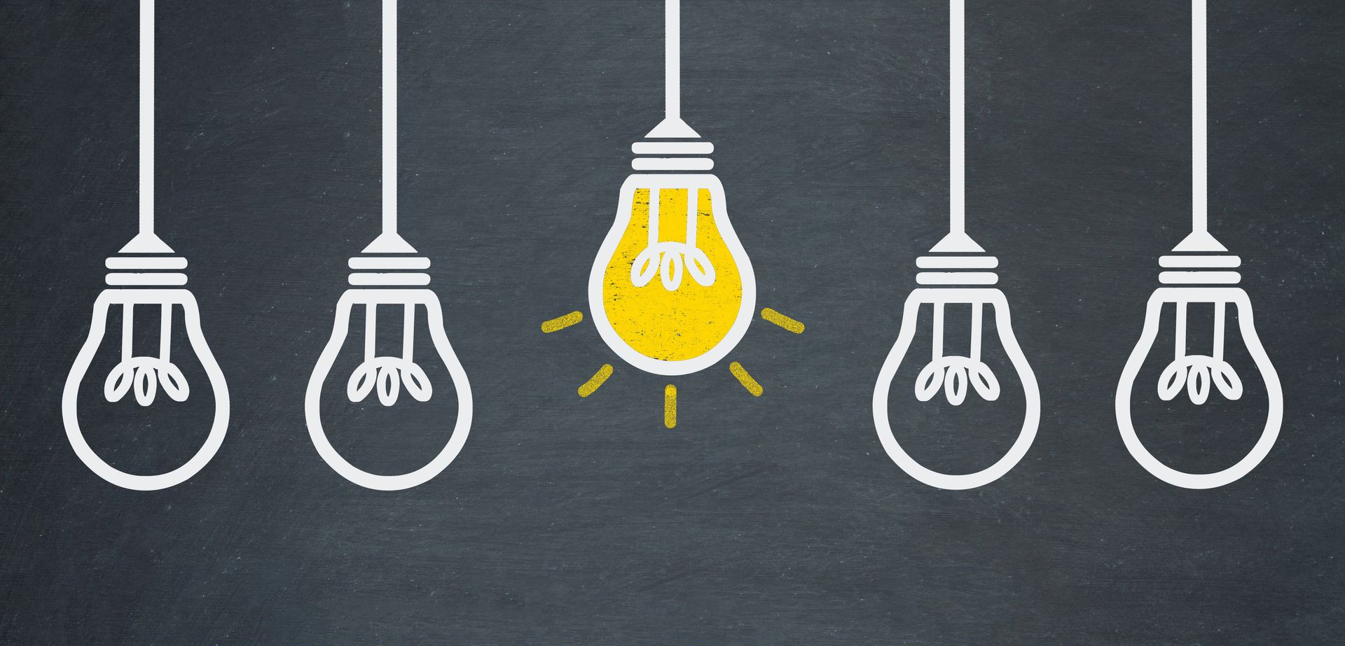 Five lightbulbs hanging on a dark background. One is lit, yellow; the others are white.