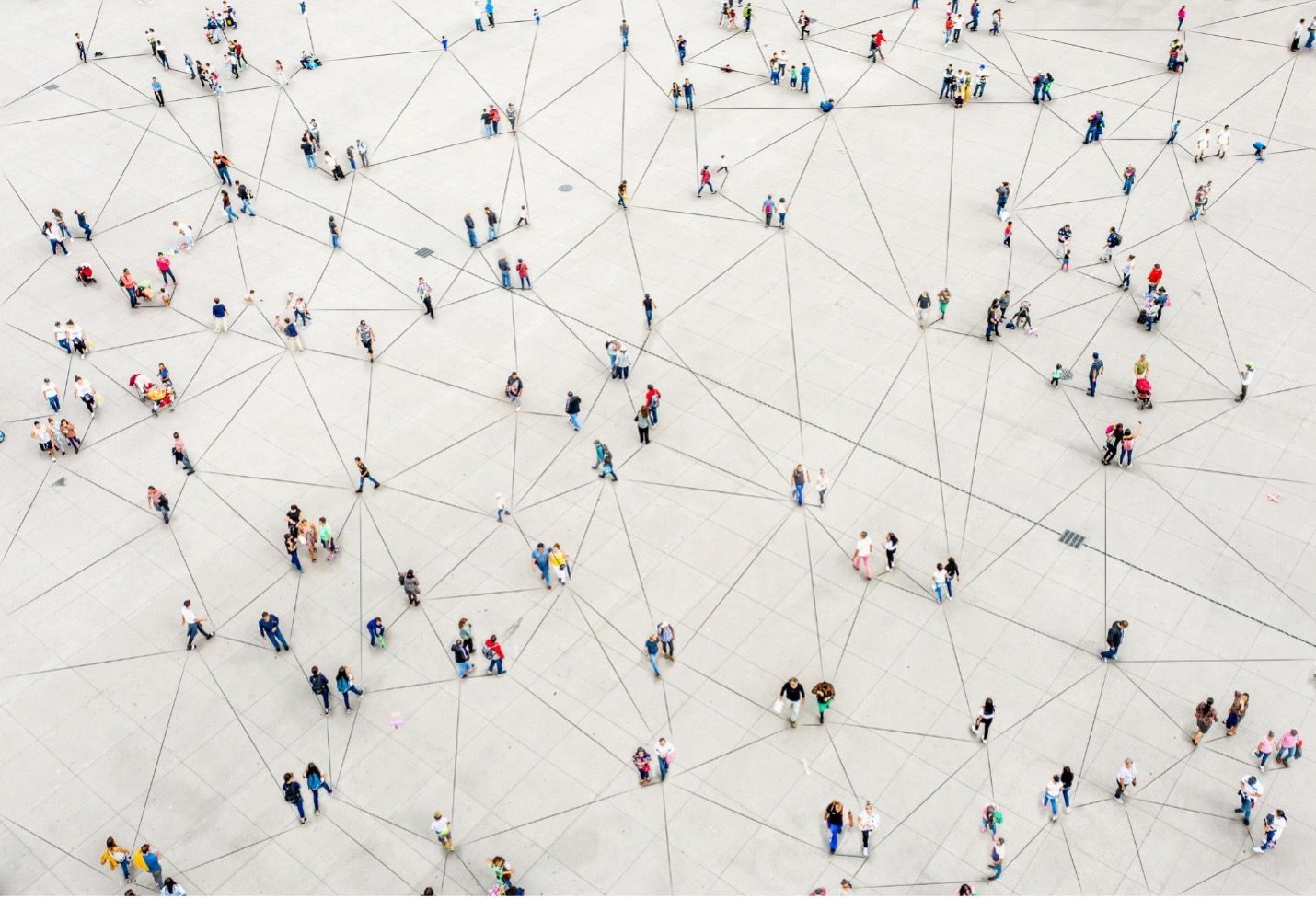 People walking on a plaza, interconnected by dotted lines, suggesting a network.