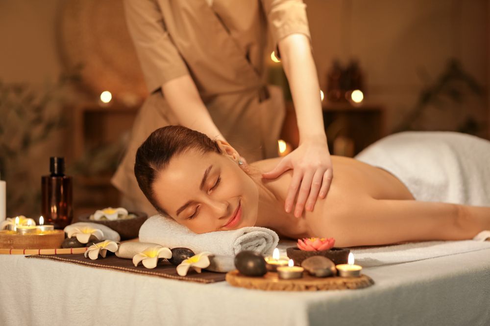 Young woman getting a massage in spa salon.