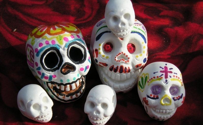 Sugar skulls, Día de Muertos decorations, colorful and white.