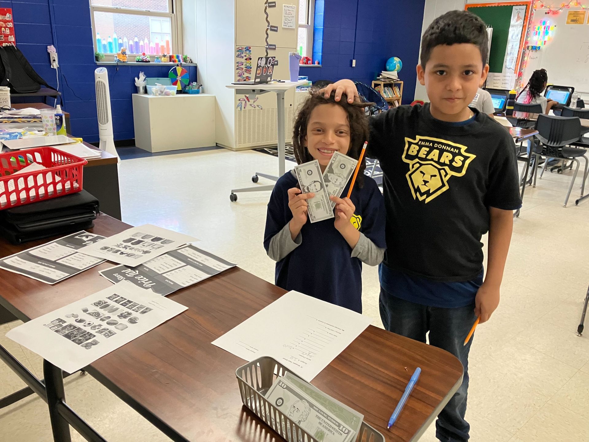 Third grade scholars making learning practical in math class