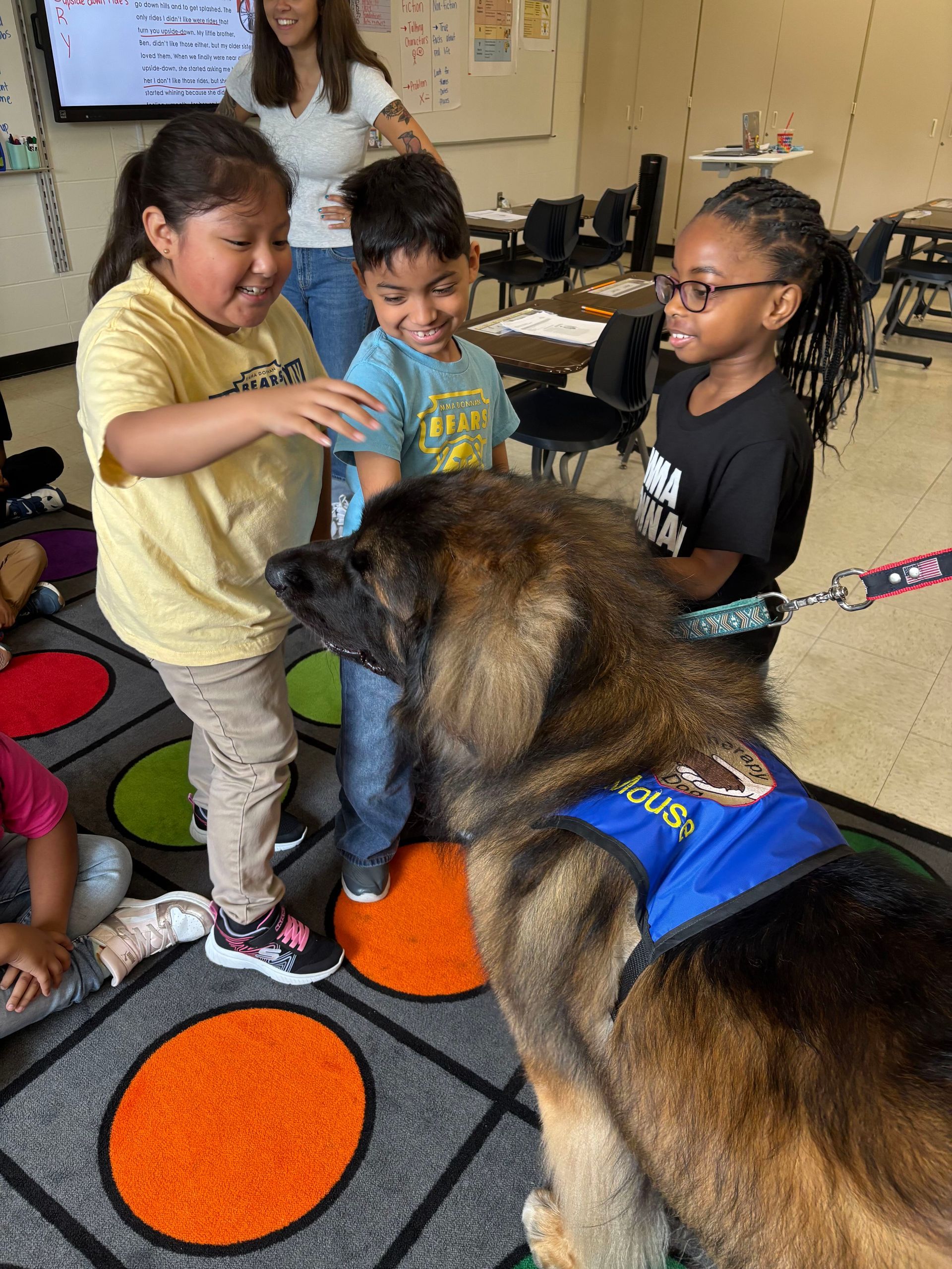 Mouse the therapy dog visiting with scholars in the classroom