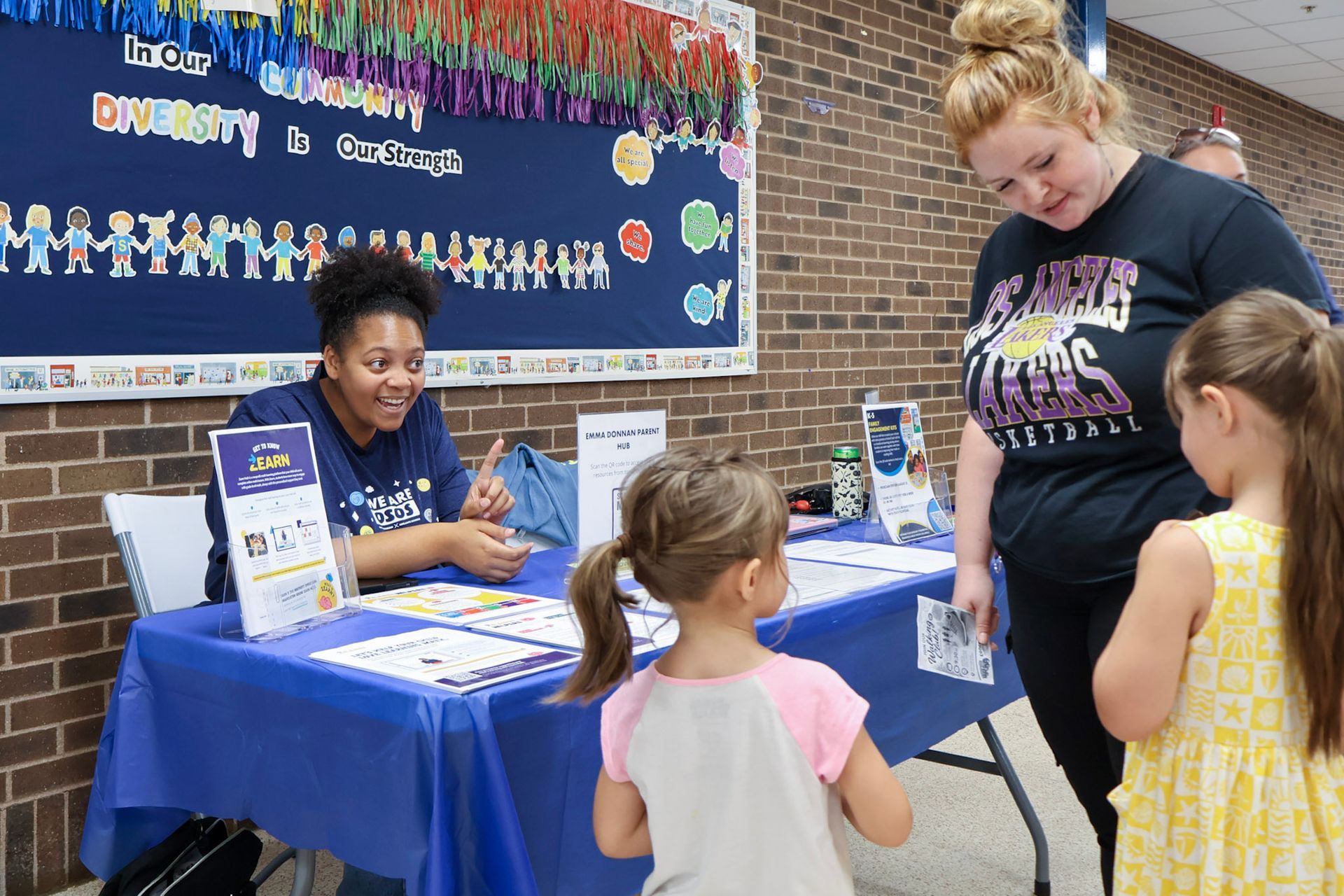 Families talking with Emma Donnan staff at the Back to School Bash and Open House