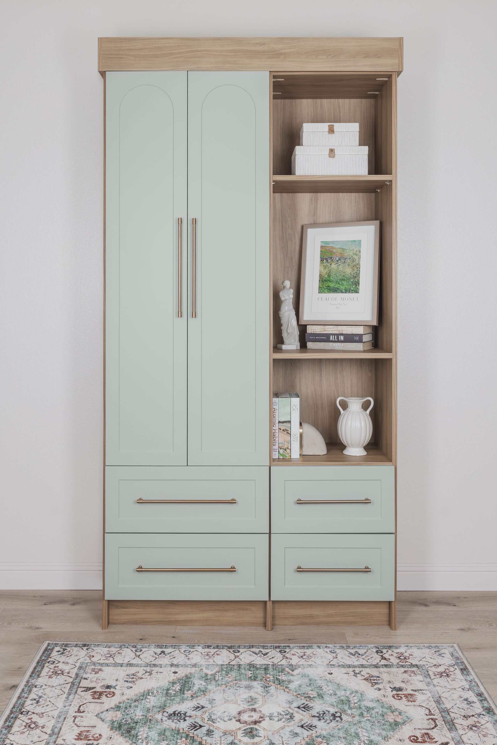 Tall two-tone wooden cabinet with pale doors, open shelves, and drawers against a wall above a patterned rug.