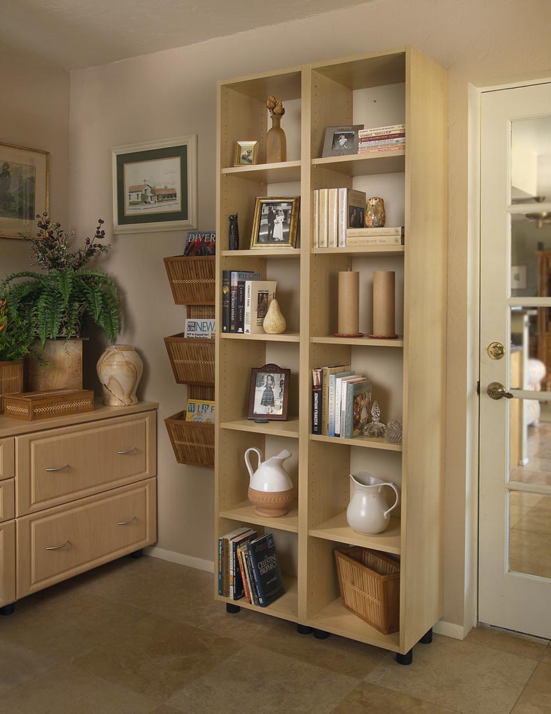A bookshelf with a lot of books and pictures on it