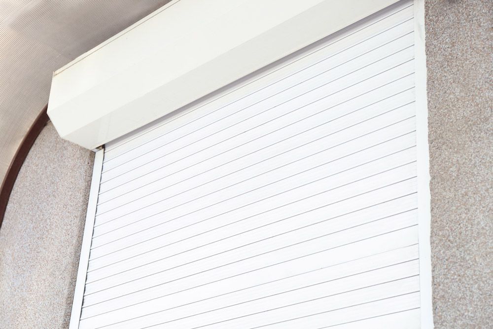 Window With Closed Roller Shutter — Window Coverings in Cardiff, NSW