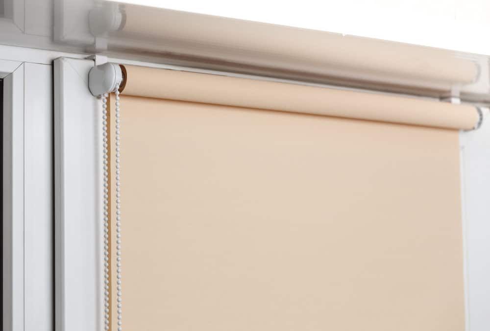 Beige Blackout Roller Blinds On White Plastic Window