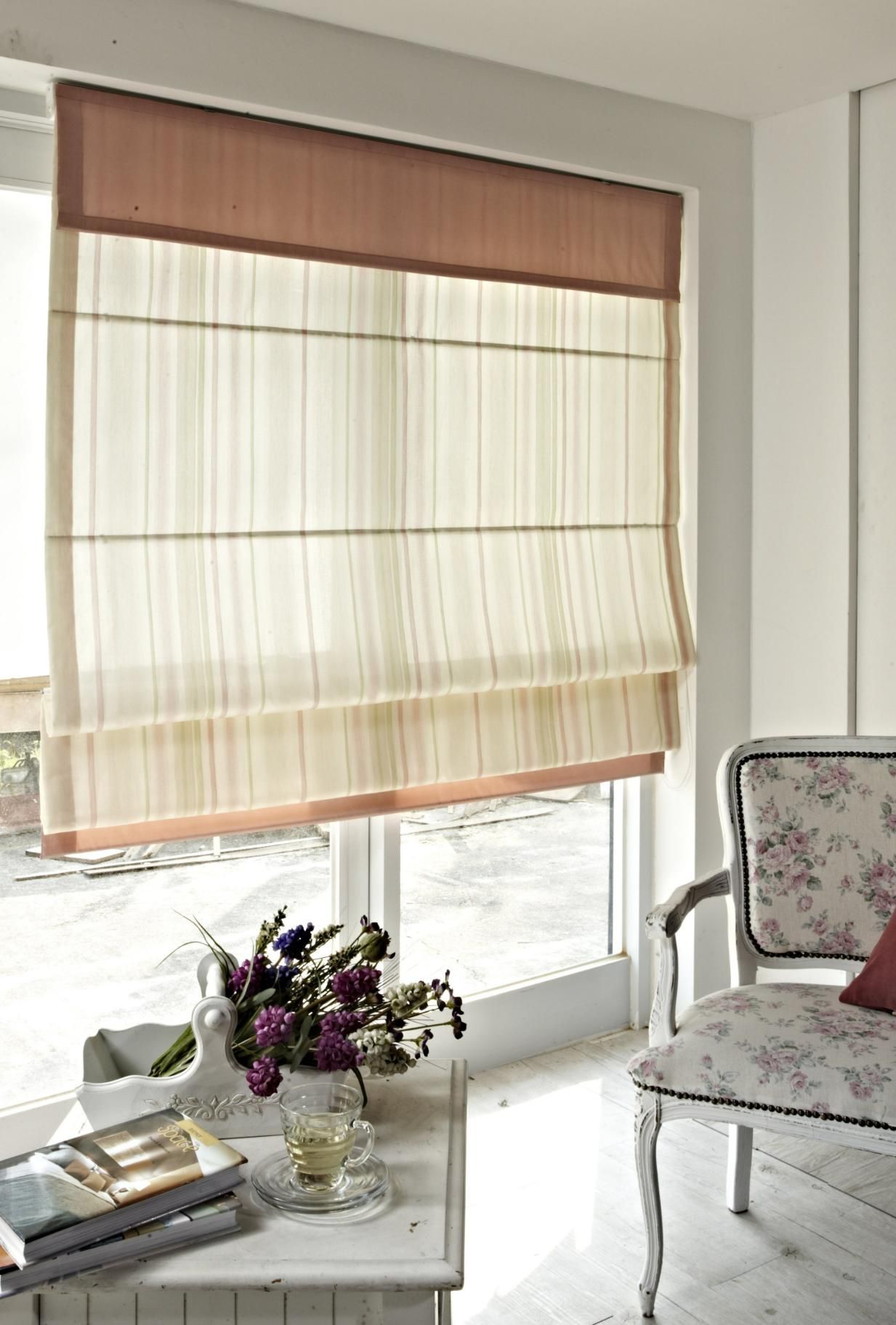 A Table With a Vase of Flowers and a Cup of Tea on It — Window Coverings in Cardiff, NSW