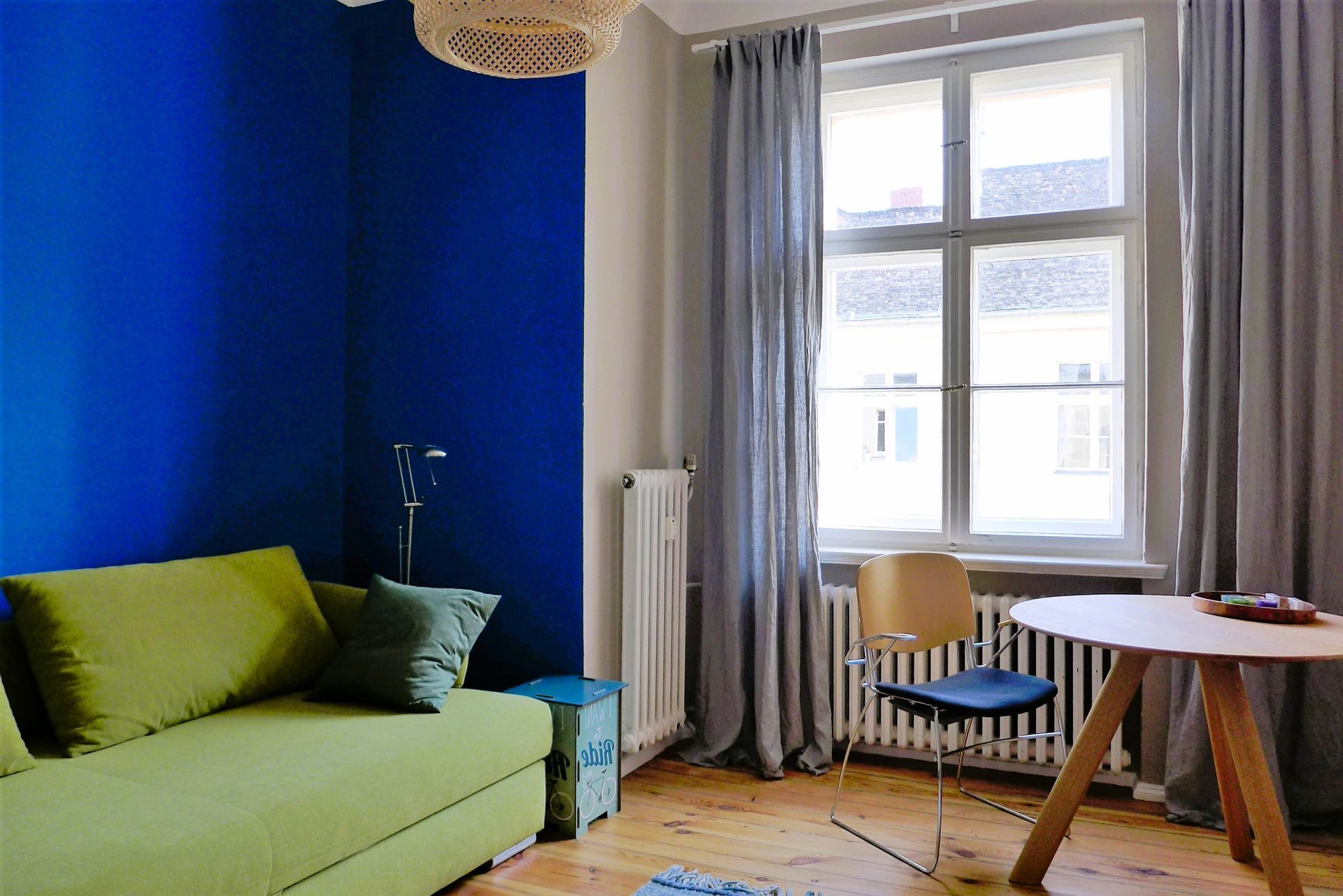 Ein Wohnzimmer mit einer grünen Couch und einem Tisch