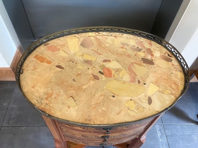 Large round pot of chunky stew or soup on a stand in a kitchen.