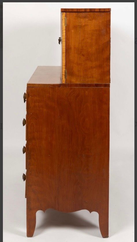 Wooden cabinet with a smaller upper compartment, shown against a plain background.