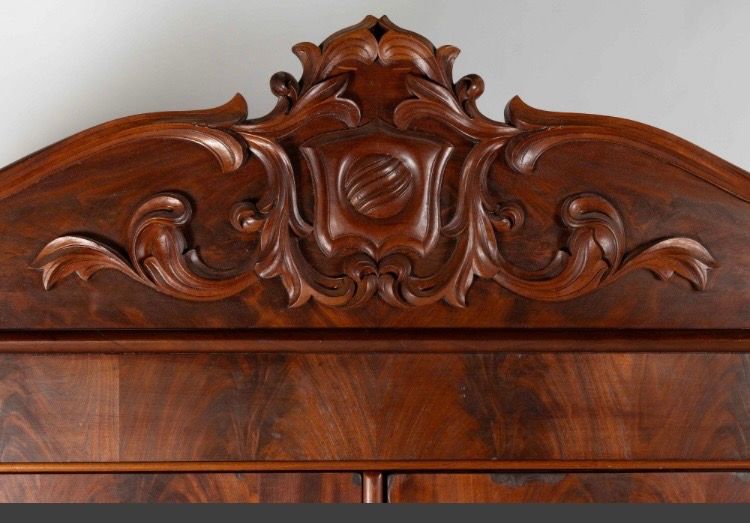 Ornate carved wooden headboard with dark polished finish