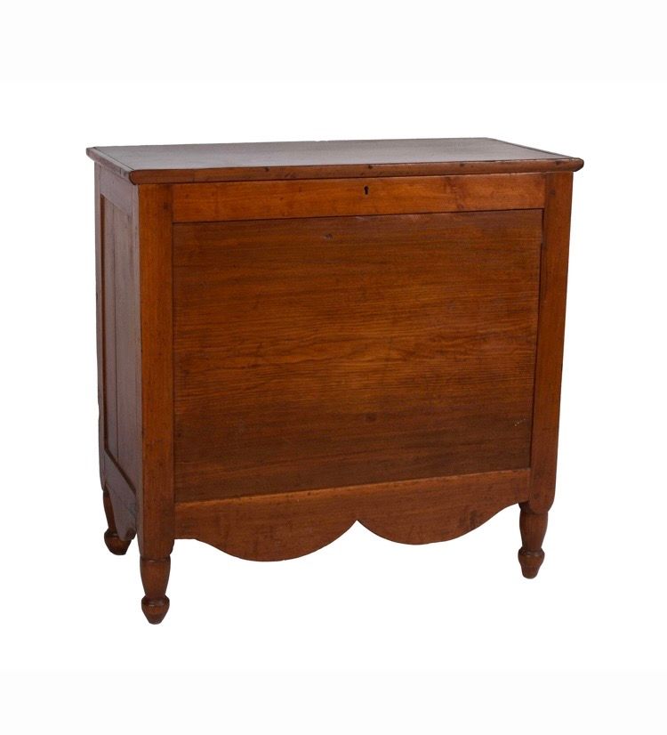 Wooden storage chest with curved front and four legs on a white background Wooden storage chest with curved front and four legs on a white background
