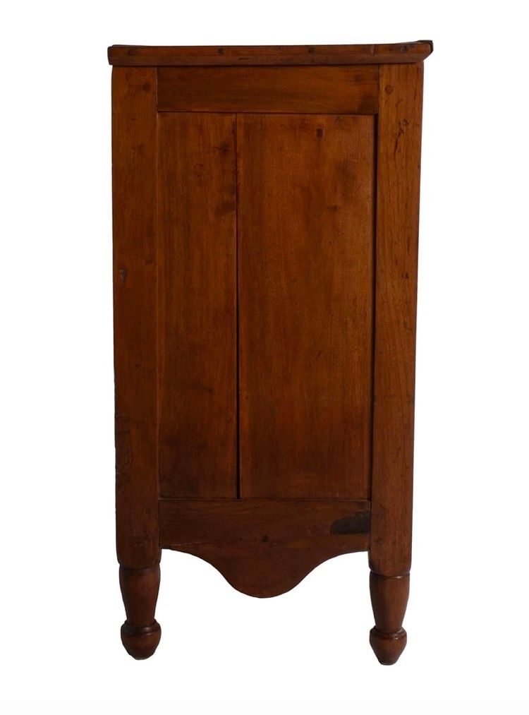 Vintage wooden cabinet with a curved front and two rounded legs on a white background