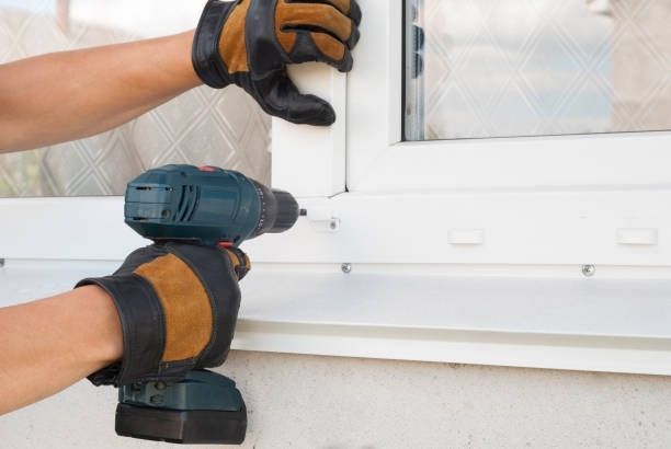 Man Fixing Window — Fort Atkinson, WI — SCHLOESSER CONSTRUCTION
