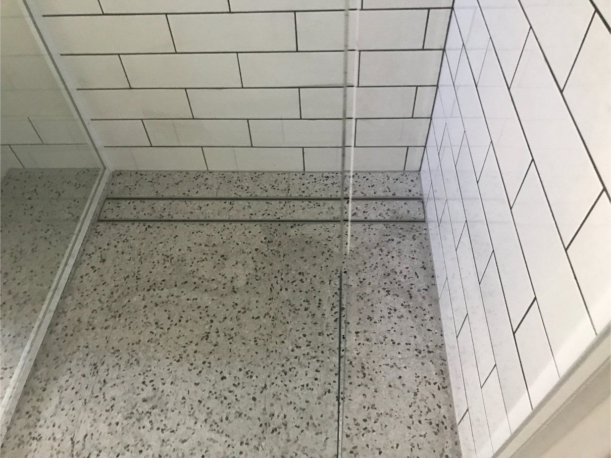 Shower Interior With White Subway Tile and Terrazzo-patterned Walls — Worrall Tiling in South Kempsey, NSW