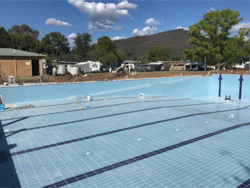 Empty Blue Swimming Pool With Lane Markers — Worrall Tiling in Crescent Head, NSW