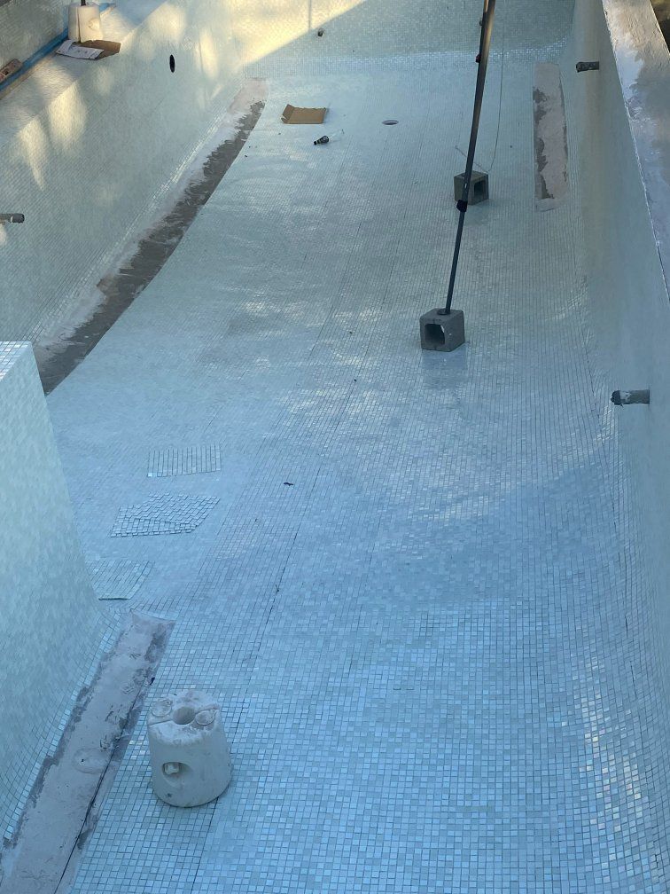 Pool Under Construction With Blue Tiles, Pipes, and Concrete in an Outdoor Setting — Worrall Tiling in South Kempsey, NSW