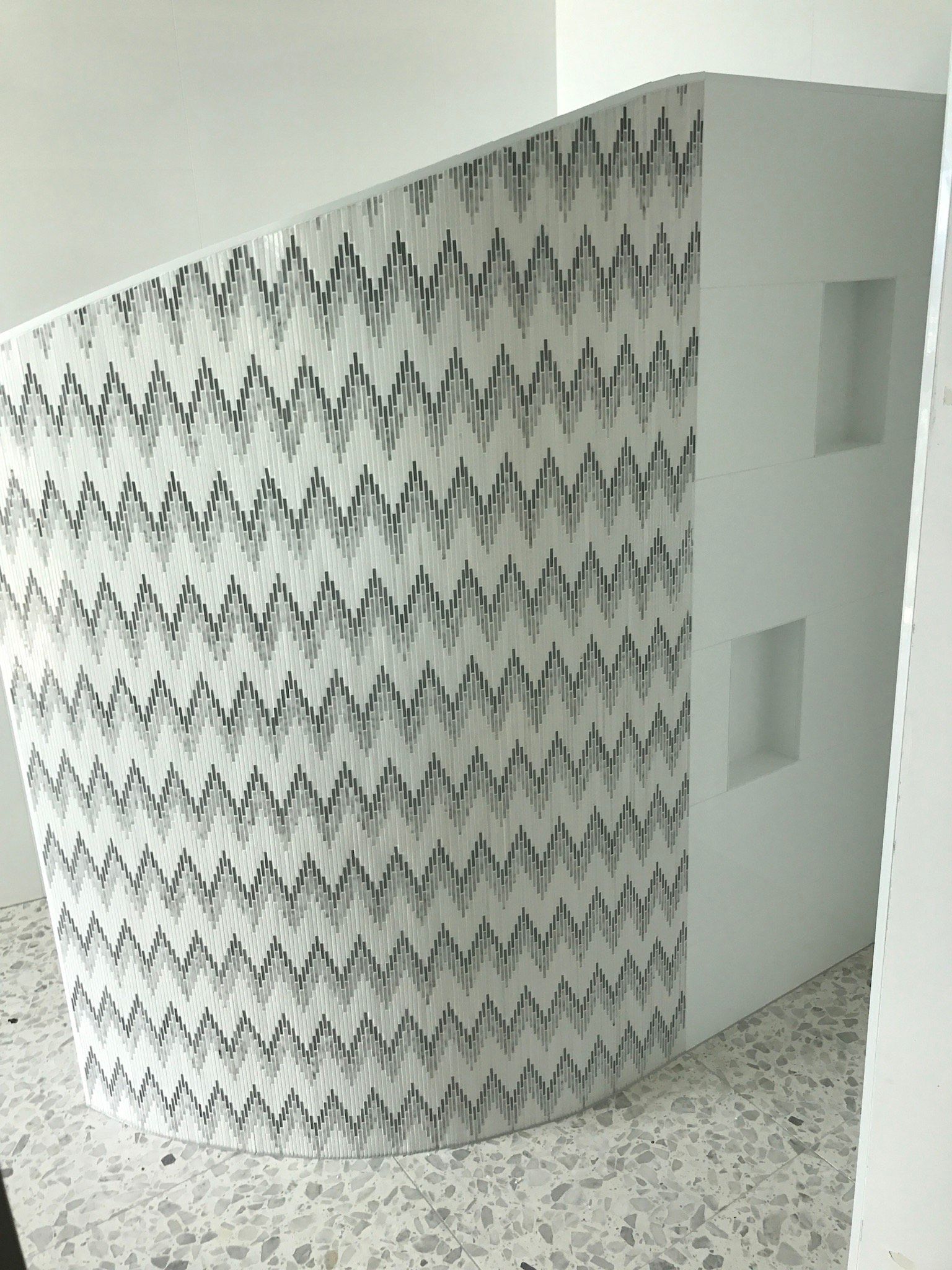 White abstract wall with zigzag pattern, two small square windows. — Worrall Tiling in South Kempsey, NSW