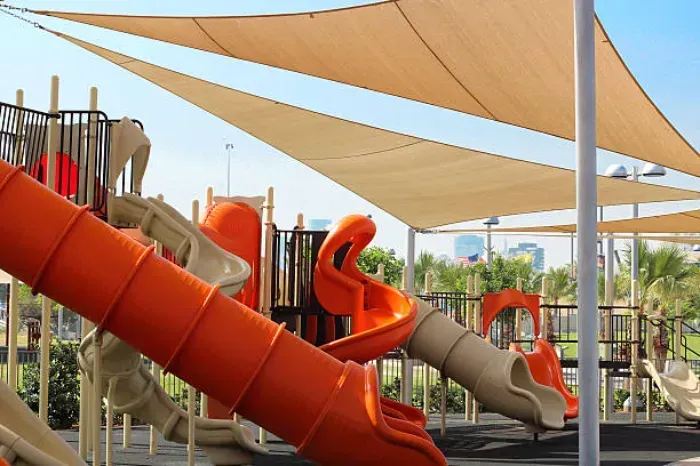 A playground with a lot of slides and shades