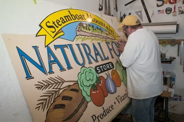 Man Hand Painting A Wall | Boulder, CO | Brush-On Signs