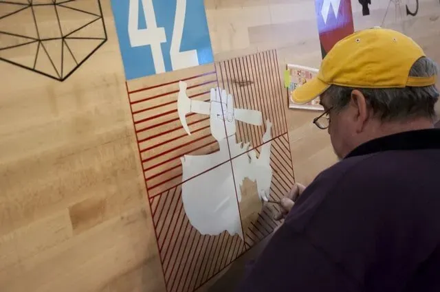 Man Painting Some Logo To A Wall | Boulder, CO | Brush-On Signs
