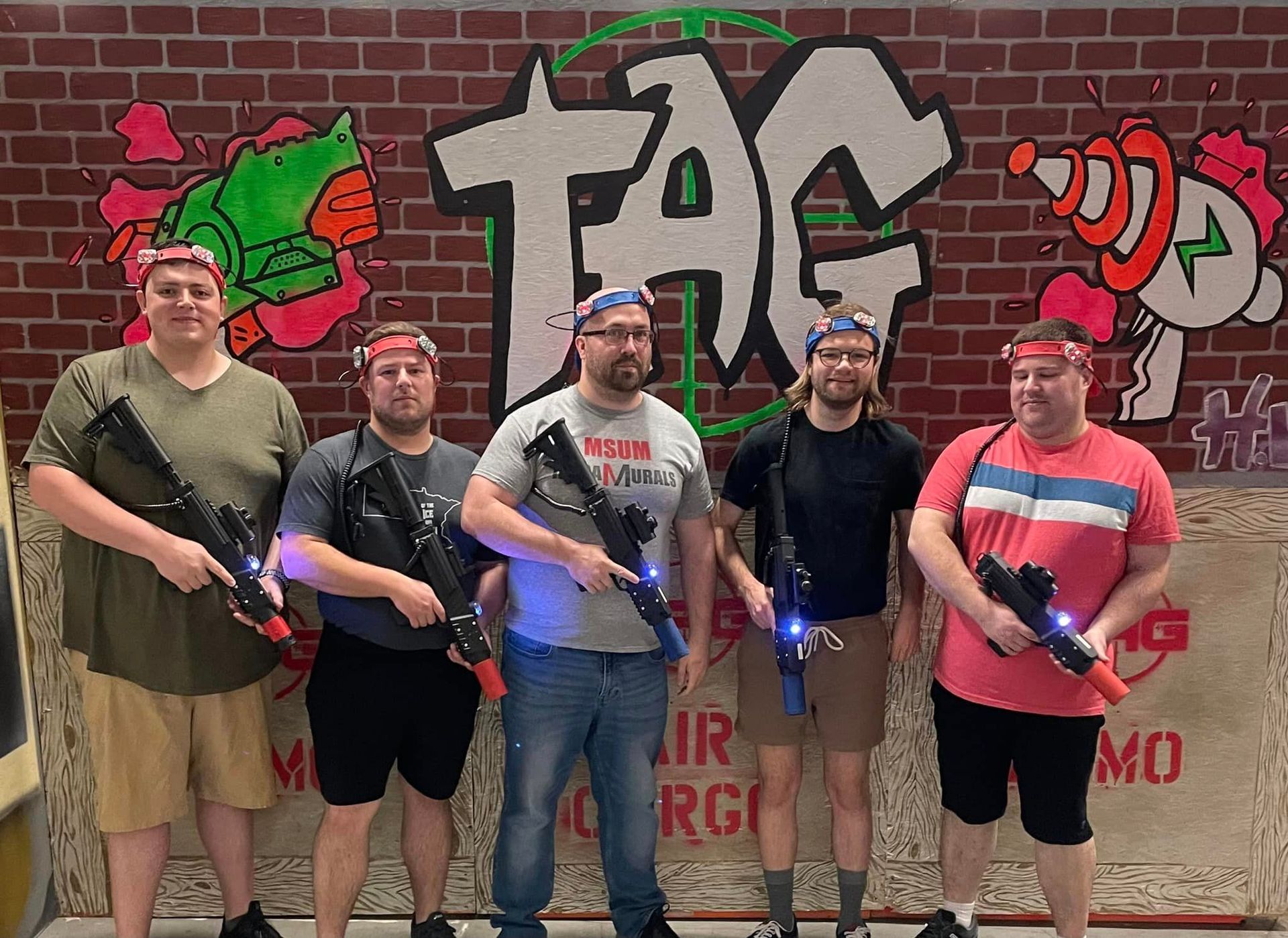 five adult men dressed to play laser tag at a bachelor party