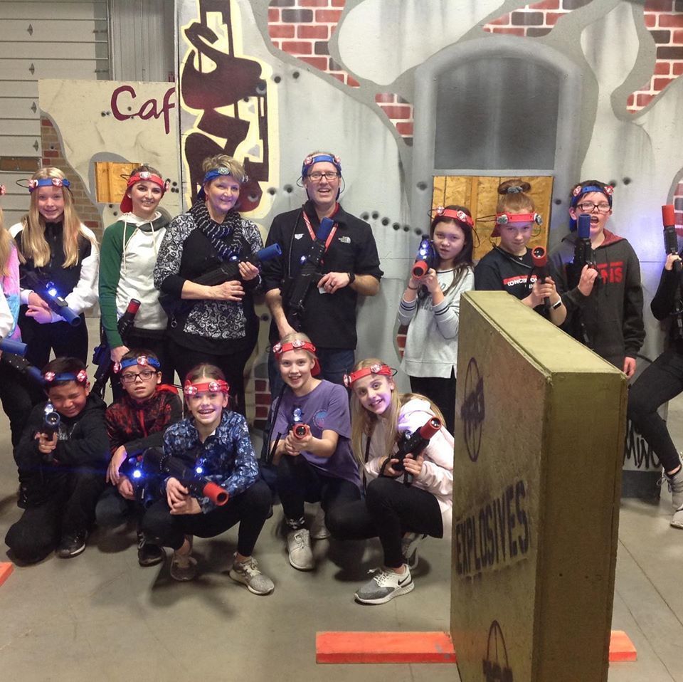 group of kids with adult conselors dreed to play laser tag at tactical action gaming