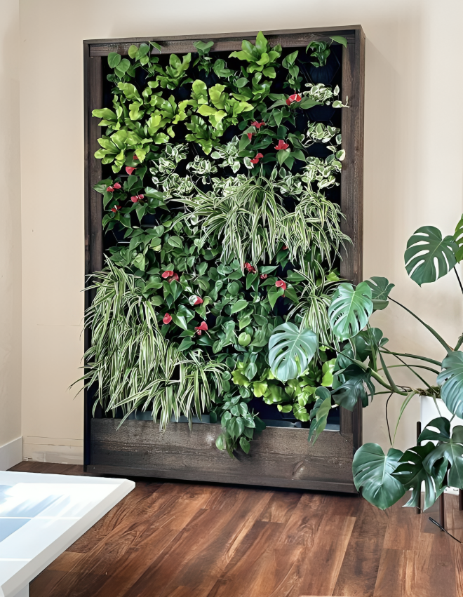 A living room with a wall filled with lots of plants and flowers.