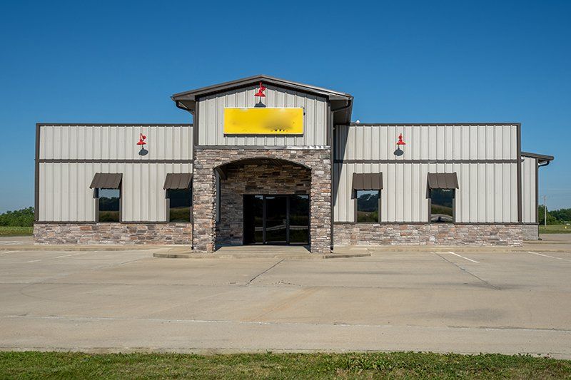 A large building with a yellow sign on the front of it.