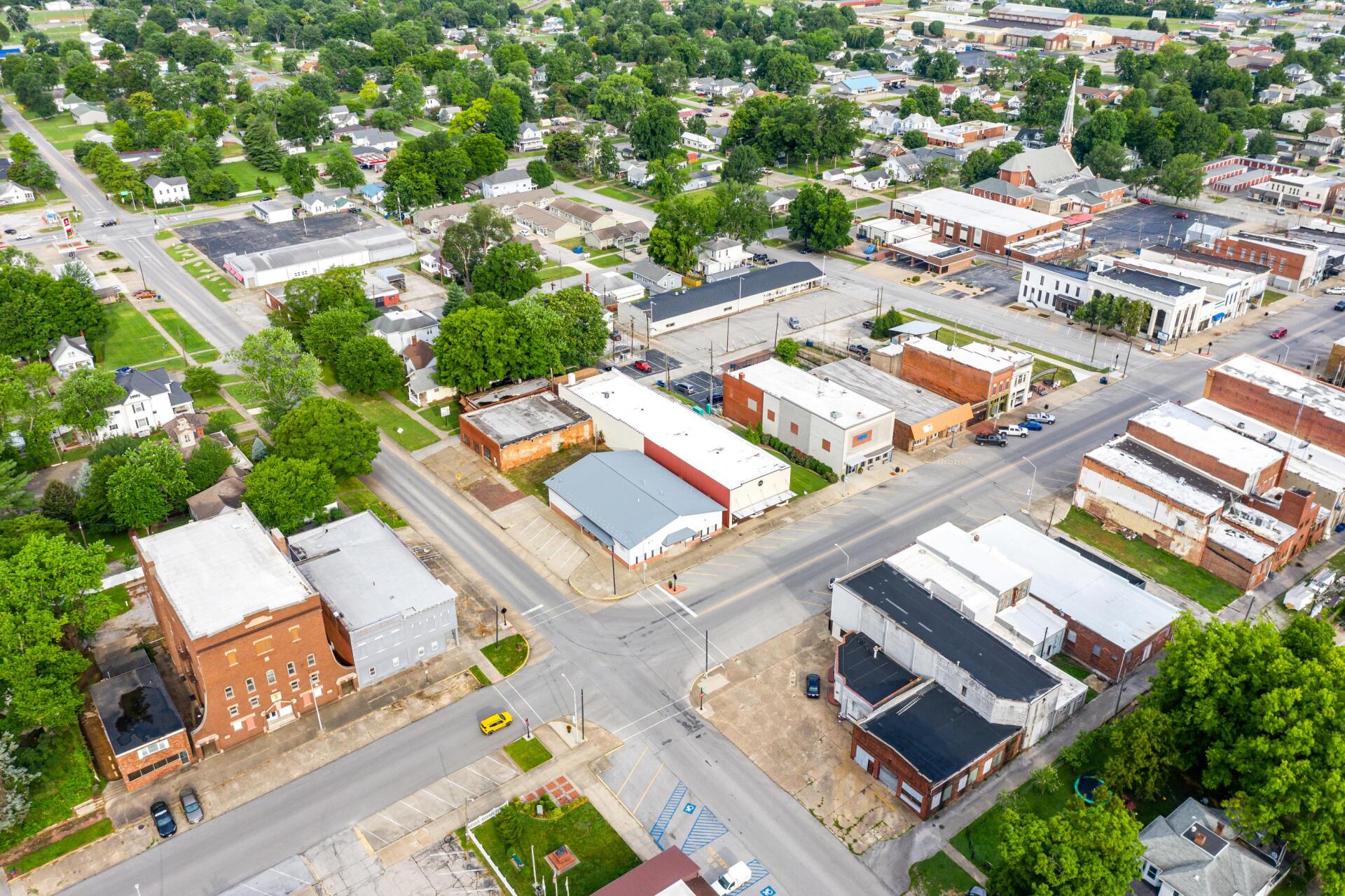 An aerial view of a small town with lots of buildings and trees.