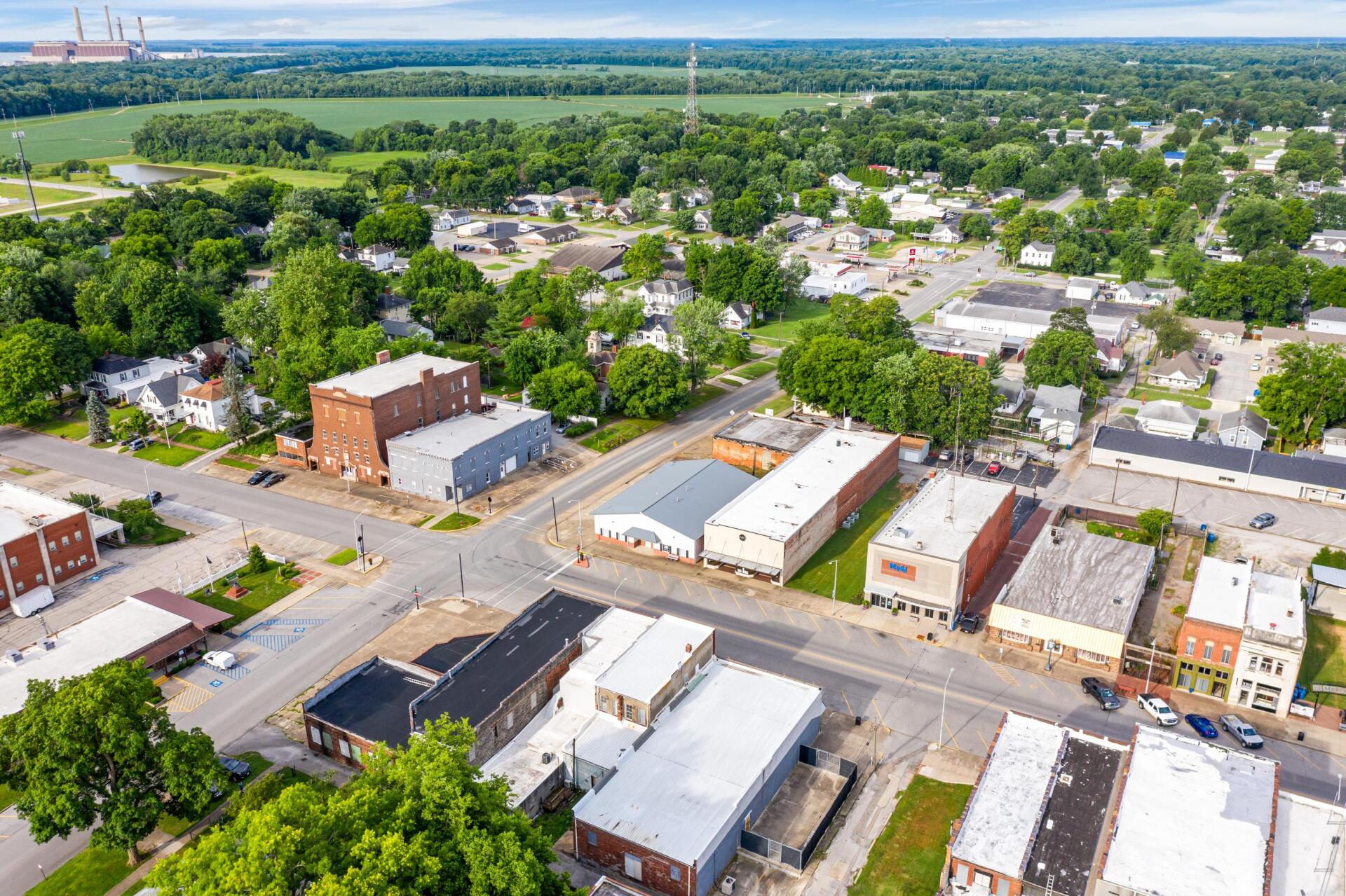 An aerial view of a small town with lots of buildings and trees.