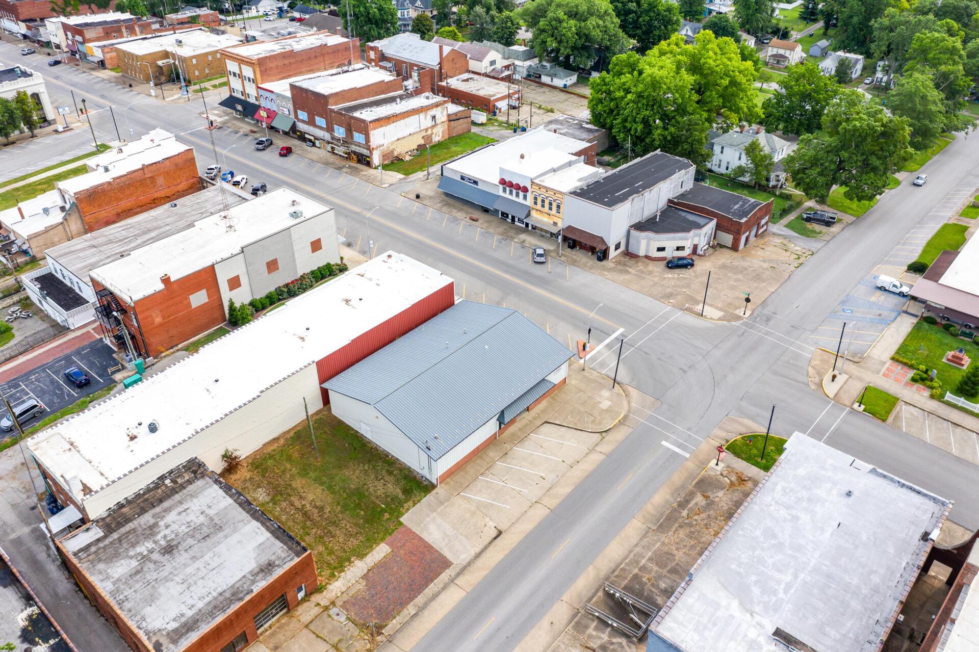 An aerial view of a small town with lots of buildings and trees.