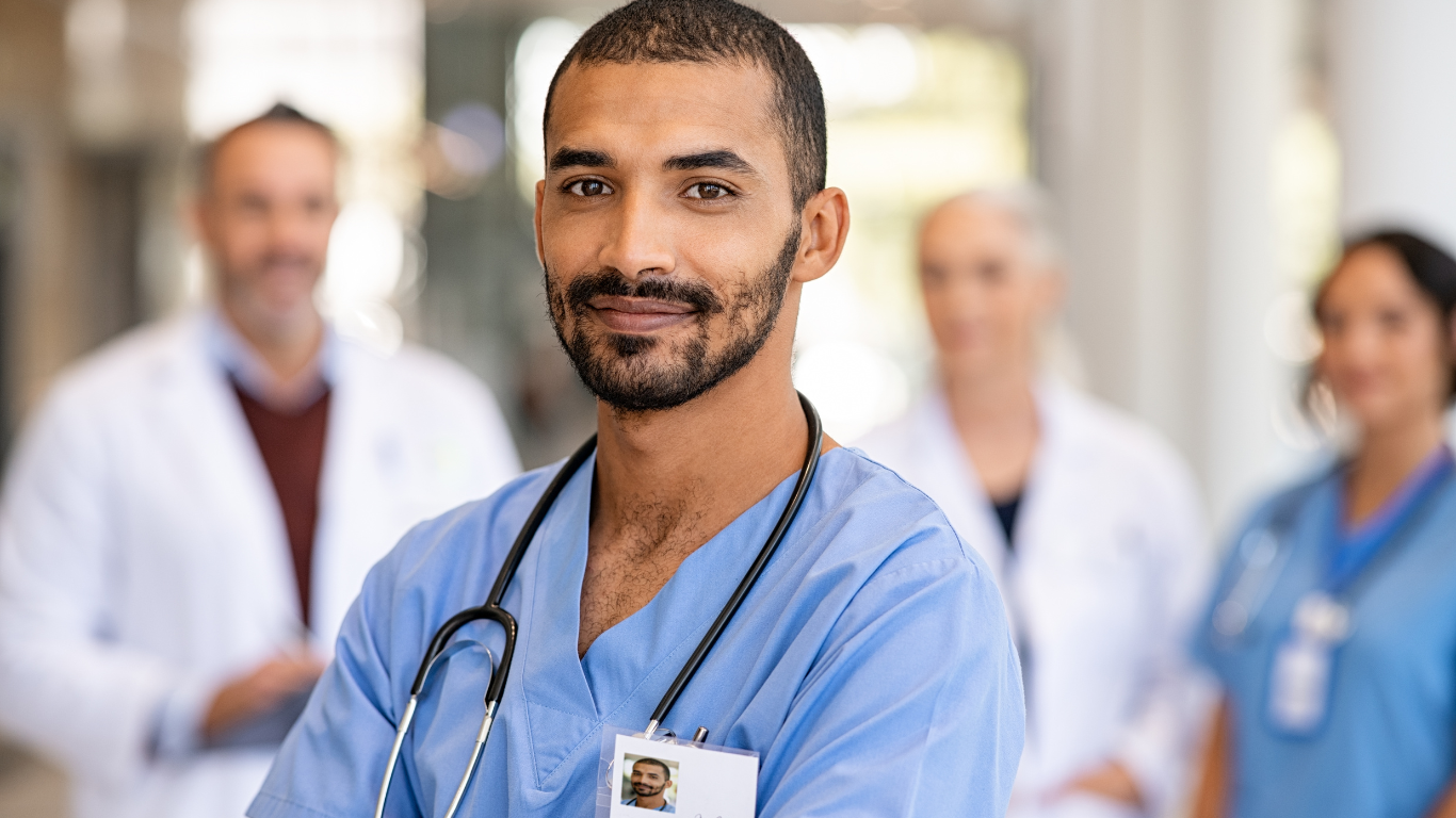 A group of doctors and nurses are standing next to each other in a hospital.