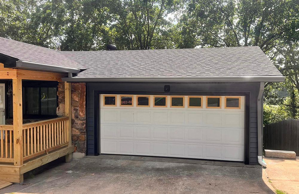 A house with a garage door and a porch.