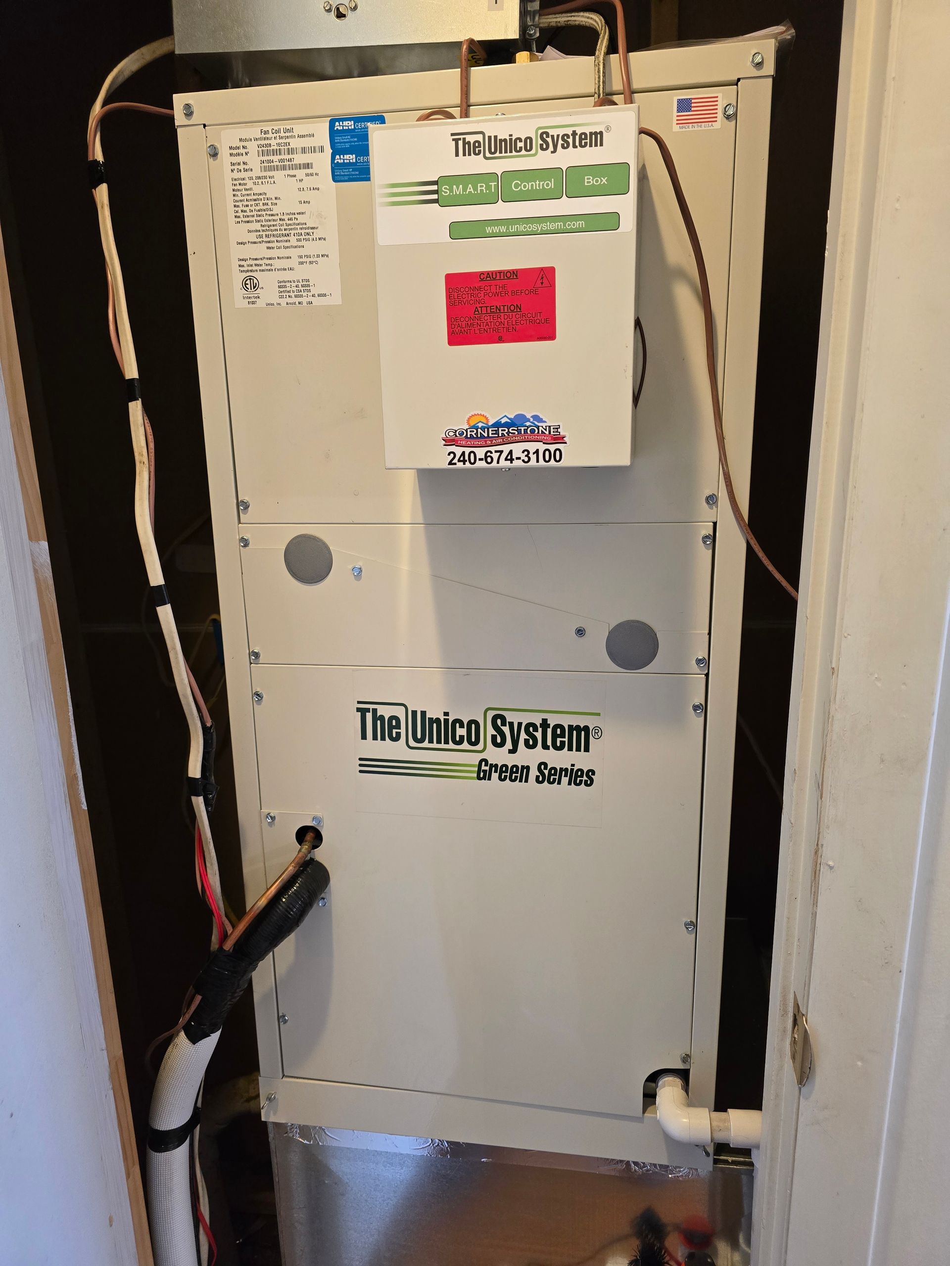 Utility meter panel and labeled electrical equipment in a narrow indoor alcove.
