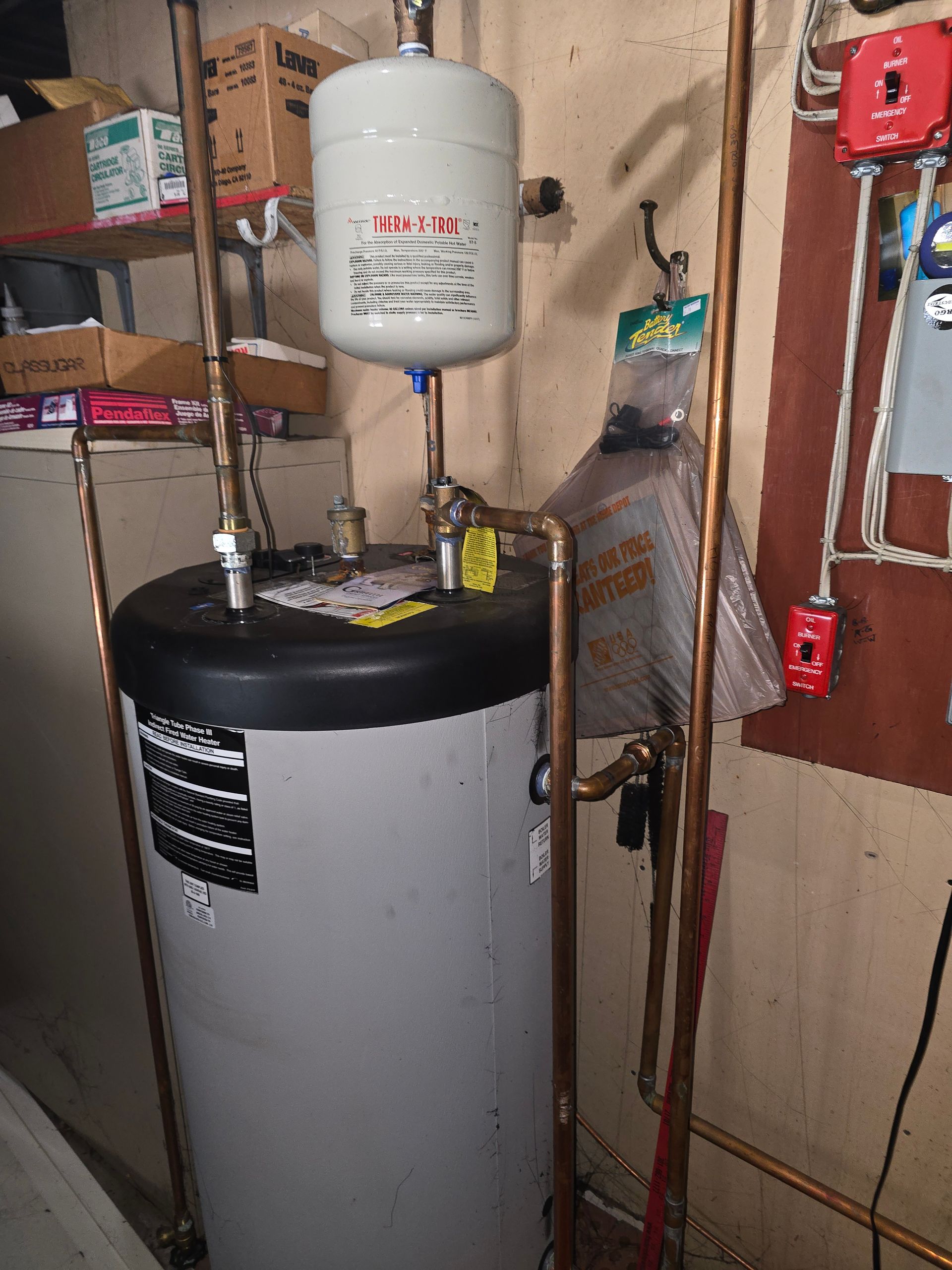 Water heater with pressure tank in a cluttered basement utility area