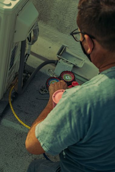 Technician inspecting gauges and hoses inside an aircraft cockpit area
