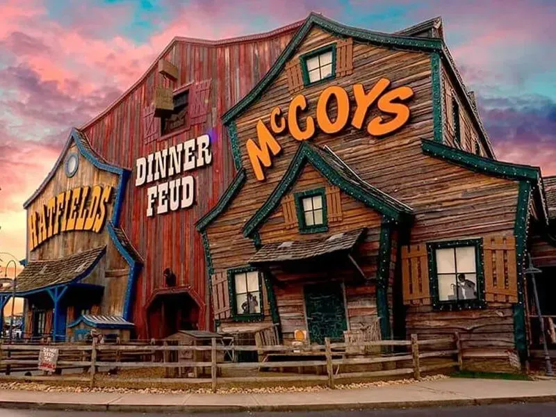 Rustic McCoy’s diner façade with large signs, weathered wood, and a pink sunset sky