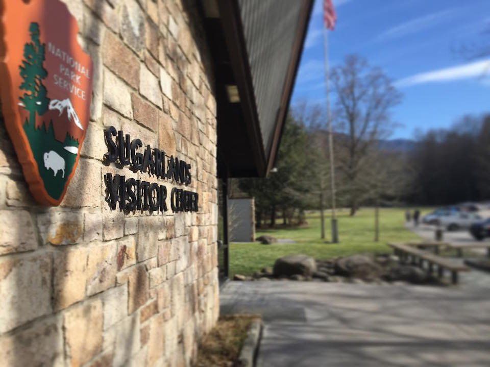 A stone wall with the National Park Service logo and the text 