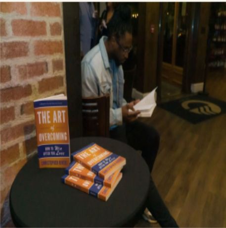 Man reading a book titled 